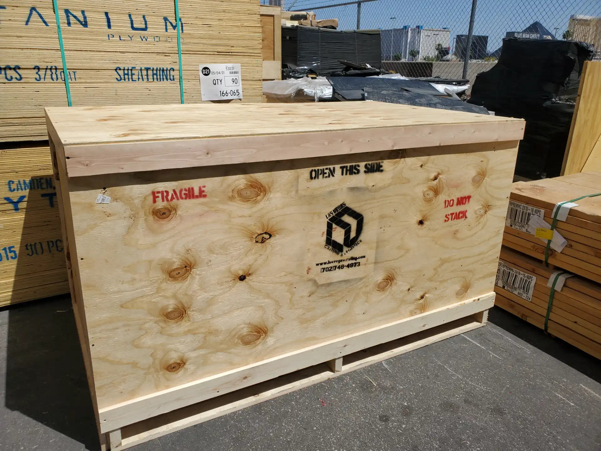 Custom crate labeled Fragile and Do Not Stack outside the warehouse